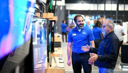 Best Buy associate helping customer shop for a television for the Big Game.